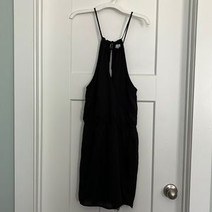 Little black dress sleeveless, open back, crisscross front, lace accent at hem